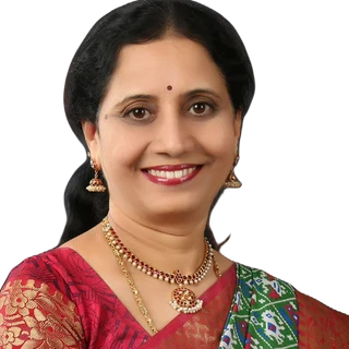Studio portrait of Dr. P. Lakshmi Satish in a red and gold saree.